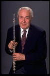 Publicity shot of musician Julian Baker holding flute (New York)