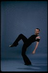 Publicity shot of director/choreographer Michael Bennett dancing in studio (New York)