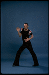 Publicity shot of director/choreographer Michael Bennett dancing in studio (New York)