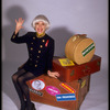 Actress Carol Channing sitting on steamer trunks in publicity photo for tour of musical "Hello, Dolly" (New York)