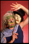 Publicity shot of performer Fred Curchack wearing mask in theater piece "The Stuff That Dreams Are Made Of" at the Brooklyn Academy of Music (New York)