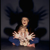 Publicity shot of performer Fred Curchack wearing mask in theater piece "The Stuff That Dreams Are Made Of" at the Brooklyn Academy of Music (New York)