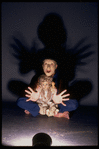 Publicity shot of performer Fred Curchack wearing mask in theater piece "The Stuff That Dreams Are Made Of" at the Brooklyn Academy of Music (New York)