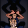 Publicity shot of performer Fred Curchack wearing mask in theater piece "The Stuff That Dreams Are Made Of" at the Brooklyn Academy of Music (New York)