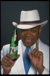 Publicity photo of designer/director/choreographer/actor Geoffrey Holder holding bottle of 7up (New York)