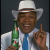 Publicity photo of designer/director/choreographer/actor Geoffrey Holder holding bottle of 7up (New York)