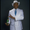 Publicity photo of designer/director/choreographer/actor Geoffrey Holder holding bottle of 7up (New York)