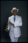 Publicity photo of designer/director/choreographer/actor Geoffrey Holder holding bottle of 7up (New York)