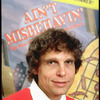 Publicity photo of director Richard Maltby Jr. standing in front of poster of his show "Ain't Misbehavin'" (New York)