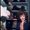 Opera singer Anna Moffo posing in closet in her eastside brownstone filled with fur hats (New York)