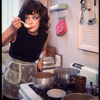 Opera singer Anna Moffo cooking in kitchen of her eastside brownstone (New York)