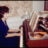 Opera singer Anna Moffo playing the piano in the music room of her eastside brownstone (New York)
