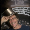 Producer Joseph Papp posing with top hat from "A Chorus Line" on occasion of its becoming the longest running Broadway musical (New York)