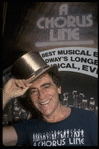 Producer Joseph Papp posing with top hat from "A Chorus Line" on occasion of its becoming the longest running Broadway musical (New York)