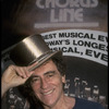 Producer Joseph Papp posing with top hat from "A Chorus Line" on occasion of its becoming the longest running Broadway musical (New York)