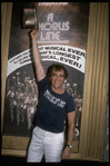 Producer Joseph Papp posing in front of Shubert Theatre with top hat from "A Chorus Line" on occasion of it becoming the longest running Broadway musical (New York)