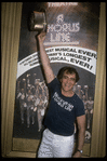 Producer Joseph Papp posing in front of Shubert Theatre with top hat from "A Chorus Line" on occasion of it becoming the longest running Broadway musical (New York)