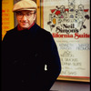 Playwright Neil Simon in front of theater where his play "California Suite" is playing (New York)