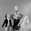 Judith Fugate as Clara, John-Pierre Frohlich as the nephew and  Shaun O'Brien as Drosselmeyer, in a New York City Ballet production of "The Nutcracker."