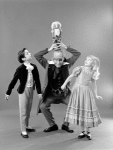 Judith Fugate as Clara, John-Pierre Frohlich as the nephew and  Shaun O'Brien as Drosselmeyer, in a New York City Ballet production of "The Nutcracker."
