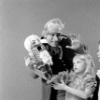 Judith Fugate as Clara, John-Pierre Frohlich as the nephew and  Shaun O'Brien as Drosselmeyer, in a New York City Ballet production of "The Nutcracker."