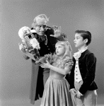 Judith Fugate as Clara, John-Pierre Frohlich as the nephew and  Shaun O'Brien as Drosselmeyer, in a New York City Ballet production of "The Nutcracker."