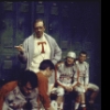 Actor John Payne (standing) with cast members in a scene from the Broadway musical "Good News" (New York)