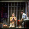 Actors Brent Carver (L) and Anthony Crivello talking in jail cell in scene from the play "Kiss of the Spider Woman" based on Manuel Puig novel.