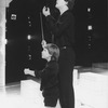 (L-R) Actors Cameron Johann and Raul Julia conducting in a scene from the Broadway production of the musical "Nine.".