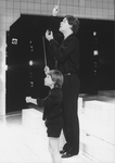(L-R) Actors Cameron Johann and Raul Julia conducting in a scene from the Broadway production of the musical "Nine.".