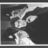 Actor Raul Julia with two dancers in bkgrd. in a scene from the Broadway production of the musical "Nine".