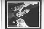Actor Raul Julia with two dancers in bkgrd. in a scene from the Broadway production of the musical "Nine".
