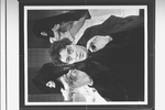 Actor Raul Julia with two dancers in bkgrd. in a scene from the Broadway production of the musical "Nine".