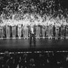 Director/choreographer Michael Bennett (C), flanked by dancers from all companies, greeting the invited audience at performance #3,389 of the Broadway production of the musical "A Chorus Line," making it the longest running show in Broadway history.