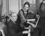Composer Richard Rodgers playing piano with actress Liv Ullmann standing over him; she will play the lead in the Broadway production of the musical "I Remember Mama.".