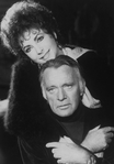 Actress Elizabeth Taylor with her arms around ex-husband, actor Richard Burton.