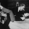 Actors Elizabeth Taylor and Richard Burton strangling each other while rehearsing a scene from the Broadway revival of the play "Private Lives".
