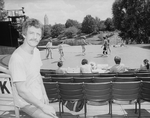 Fight choreographer B.H. Barry sitting in seats at the Delacorte theatre in Central Park with actors onstage in bkgrd. working on a fight for a NY Shakespeare Festival production.