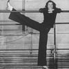 Director/choreographer Tommy Tune extending his long leg on a barre.