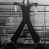 Director/choreographer Tommy Tune extending his long legs.