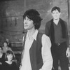 Director/choreographer Tommy Tune (C) with blurred actors Karen Akers (L) and Raul Julia in bkgrd. during a rehearsal for the Broadway production of the musical "Nine".