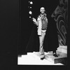 Director Geoffrey Holder wearing a black cape on the set of the Broadway production of the musical "The Wiz.".