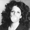 Actress Gilda Radner blowing a bubble.