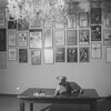 Sandy the dog lying on a table next to a chess set in the lobby of the Alvin Theatre where he performs in the Broadway production of the musical "Annie.".