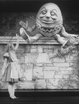 Actress Kate Burton as Alice talking to a Humpty Dumpty-like character in a scene from the Broadway revival of the play "Alice In Wonderland.".