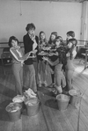 Actress Dorothy Loudon blowing a whistle as she is surrounded by orphan girls incl. Andrea McArdle (L) as Little Orphan Annie during a rehearsal for the Broadway production of the musical "Annie.".