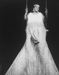 Singer Carrie Smith sitting in a giant swing in a scene from the Broadway production of the musical "Black And Blue"