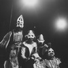 Five unidentified cast members wearing masks in a scene from the Off-Broadway production of the play "The Blacks."