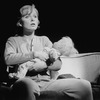 Actress Kate Burton holding a doll in a scene from the Broadway production of the musical "Doonesbury.".