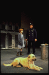 Annie, Sandy and a policeman in a scene from the Toronto production of the musical "Annie."